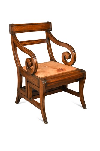 Lot 491 - A mahogany metamorphic library armchair in the manner of Morgan and Sanders, 20th century
