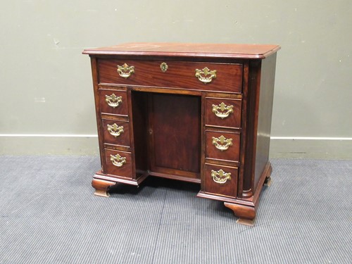 Lot 431 - A George III style mahogany kneehole desk,...