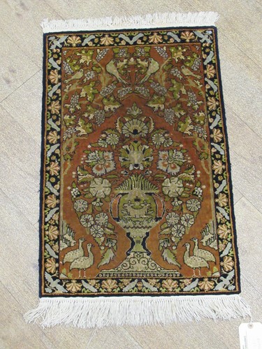 Lot 517 - A small Persian silk rug 86 x 51cm, together...