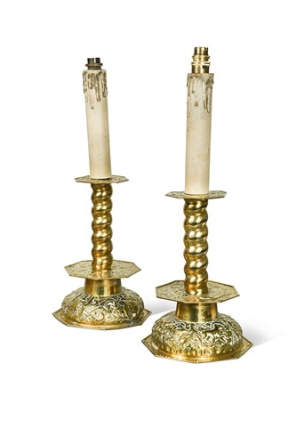 Lot 239 - A pair of pressed brass candlestick lamps, 19th century