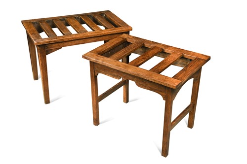 Lot 557 - A matched pair of Arts and Crafts oak luggage stands, circa 1910