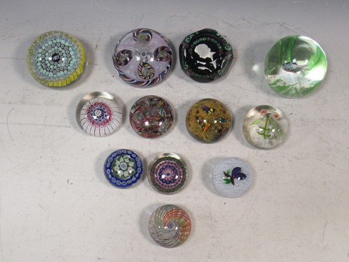 Lot 90 - A collection of glass paperweights, including...