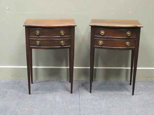 Lot 511 - A pair of bedside two drawer chests raised on...