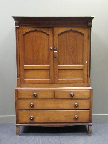 Lot 465 - An early 19th century oak linen press, with...
