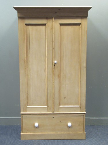 Lot 418 - An early 20th century pine two-door wardrobe...
