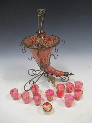 Lot 52 - A cranberry glass and gilt cornucopia drinks...