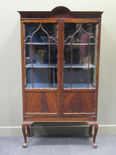 Lot 471 - A glazed mahogany cabinet with cabriole legs...