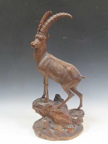 Lot 80 - A black forest carved wooden model of an Ibex,...