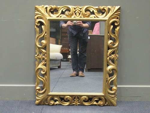 Lot 492 - A Florentine style gilt wood wall mirror, the...