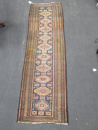 Lot 591 - A Persian runner with blue ground and ten...