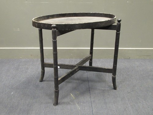 Lot 509 - An ebonised tray on stand, the oval tray on a...