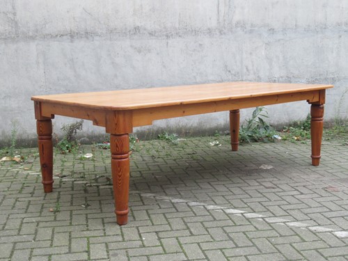 Lot 490 - A large modern pine dining table, the rounded...