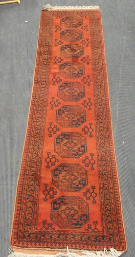 Lot 602 - An Afghan type red ground runner, 306 x 75cm