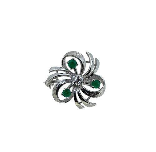 Lot 85 - An emerald and diamond floral brooch.