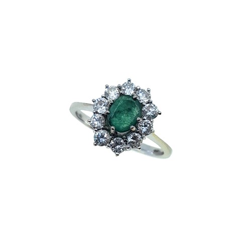 Lot 87 - A modern emerald and diamond cluster ring