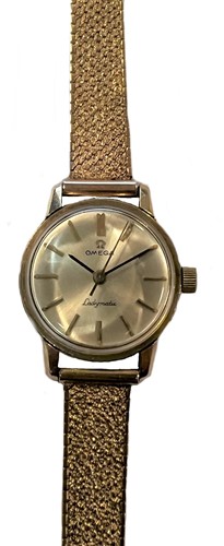 Lot 329 - Omega - A 9ct gold 'Ladymatic' wristwatch on a later 9ct gold bracelet