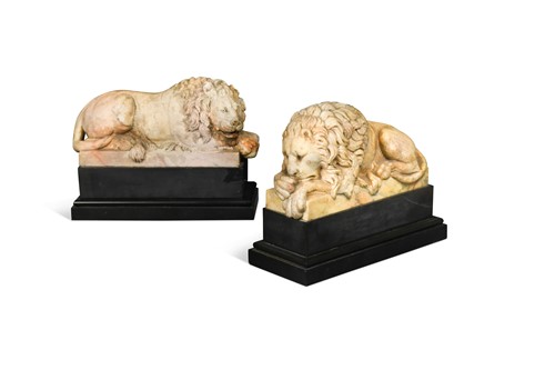 Lot 594 - A pair of Giallo di Siena marble recumbent lions after the models by Antonio Canova (Italian 1757-1822), early 20th century