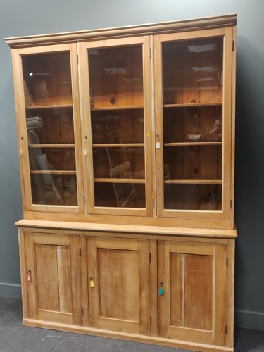 Lot 471 - A stripped pine glazed top cabinet, early 20th...