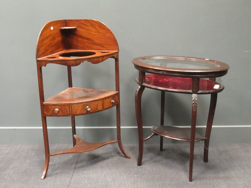 Lot 414 - A mahogany oval glazed top display table,...