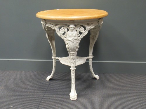 Lot 474 - A circular oak top cast iron base pub or...