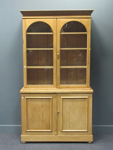 Lot 472 - A Victorian stripped pine glazed top cabinet,...
