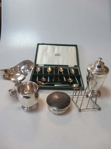 Lot 219 - A silver caster, toast rack, bon bon dish,...