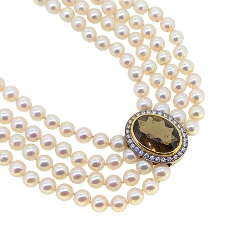 Lot 156 - A smoky quartz and diamond set four row pearl...