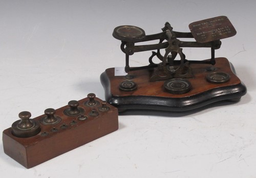 Lot 66 - A set of brass postal scales and weights