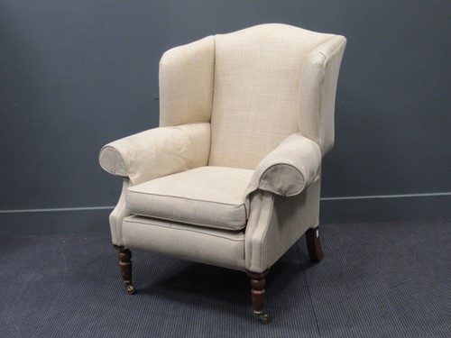 Lot 416 - A modern DURESTA wing-back armchair on turned...