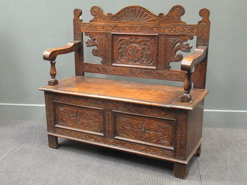 Lot 458 - A late Victorian oak monks bench, with carved...