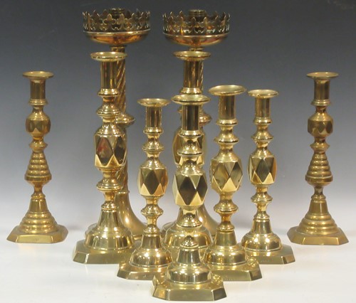 Lot 106 - Three pairs of brass candlesticks to...