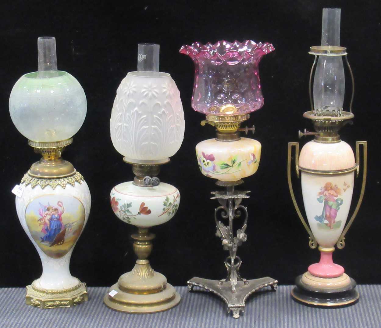 Lot 115 - Four Victorian oil lamps, 65cm tall, 63cm tall,...