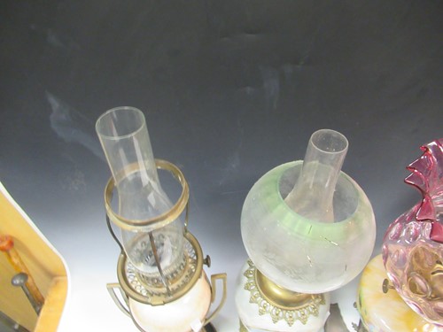 Lot 115 - Four Victorian oil lamps, 65cm tall, 63cm tall,...