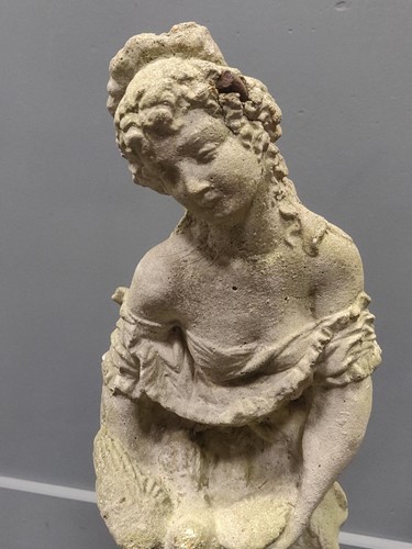 Lot 530 - A composite garden statue of a courting couple,...