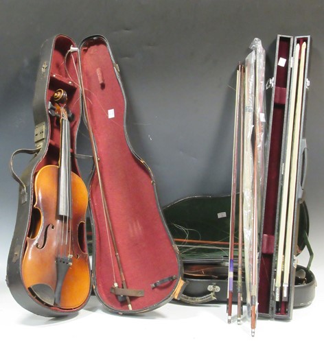 Lot 129 - Two cased violins and nine assorted bows