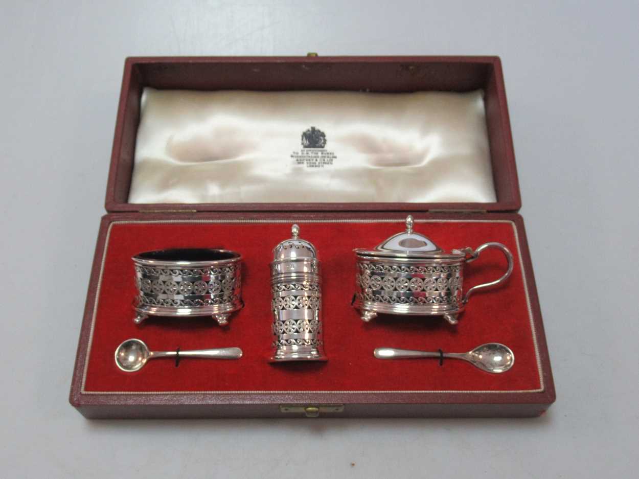 Lot 175 - A silver cruet set cased by Asprey, each main...