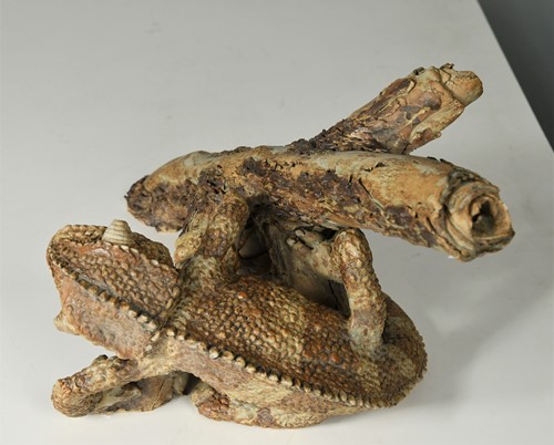 Lot 90 - David Cooke (1970-), a ceramic sculpture of a chameleon on a branch, 1996