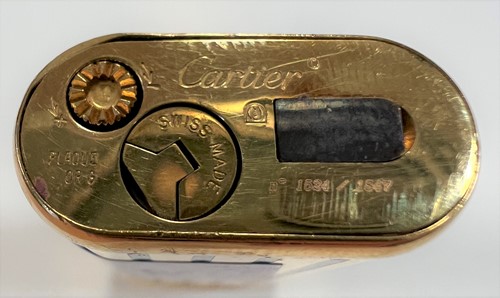 Lot 384 - Cartier - A 'Les Must de Cartier' gold plated and enamel pocket cigarette lighter