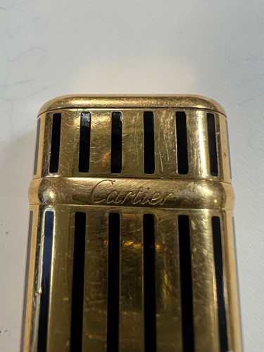 Lot 384 - Cartier - A 'Les Must de Cartier' gold plated and enamel pocket cigarette lighter