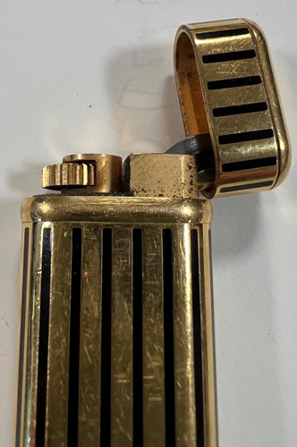Lot 384 - Cartier - A 'Les Must de Cartier' gold plated and enamel pocket cigarette lighter