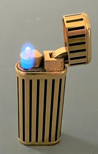 Lot 384 - Cartier - A 'Les Must de Cartier' gold plated and enamel pocket cigarette lighter