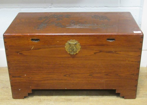 Lot 510 - A Chinese camphor wood box, the cover carved...