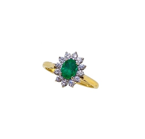 Lot 84 - An 18ct gold emerald and diamond cluster ring