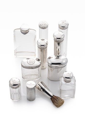 Lot 411 - A set of six early 20th century silver and glass toilet bottles with 5 additions