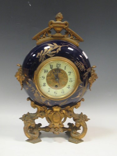 Lot 54 - A late Victorian moon shaped mantel clock with...