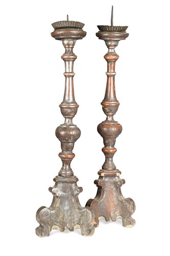 Lot 388 - A pair of Italian turned wood, red painted and silver washed tripod altar pricket candlesticks, 18th/19th century