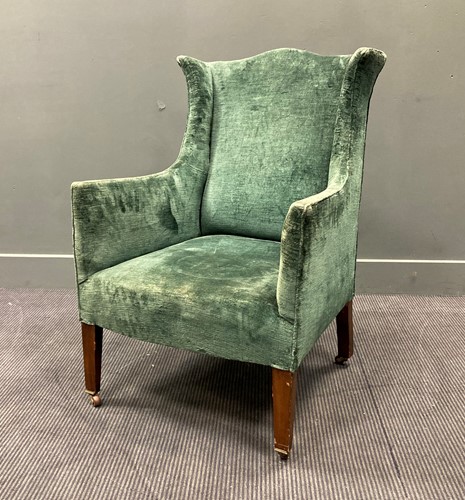 Lot 587 - An early 20th century small wing back armchair...
