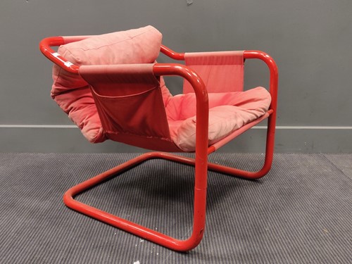 Lot 477 - A red tubular armchair, a tubular chromed...