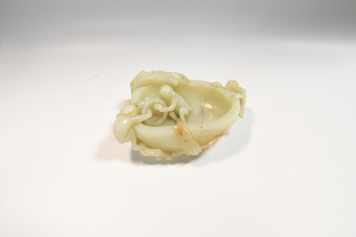 Lot 70 - A Chinese mutton fat jade ape and fruit bowl,  Qing Dynasty, 19th century