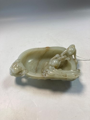 Lot 70 - A Chinese mutton fat jade ape and fruit bowl,  Qing Dynasty, 19th century